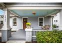 Inviting front porch with a light blue ceiling, wooden swing, and lush landscaping at 2892 Lookout Ne Pl, Atlanta, GA 30305