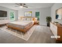Spacious main bedroom with a comfortable bed, modern furniture, and ample natural light at 120 Black Rock Ct, Fayetteville, GA 30214