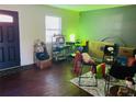 Living room with wood-look floors, a desk, and various furniture and boxes at 2711 Greystone Ct, Austell, GA 30106