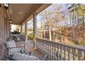 Relaxing front porch with white columns and wooded views at 195 Worth Dr, Atlanta, GA 30327