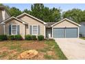 Single-story home with a two-car garage, driveway, and front yard at 2921 Ward Lake Way, Ellenwood, GA 30294