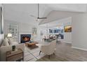 Open concept living room with fireplace, wood-look floors, and adjoining dining area at 2921 Ward Lake Way, Ellenwood, GA 30294
