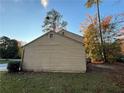 Tan siding on the side of the house with some landscaping at 5830 Burdett Ridge, Atlanta, GA 30349