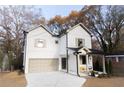 Modern two-story home with a welcoming front porch and convenient attached garage at 2455 Claude Nw St, Atlanta, GA 30318