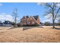 Brick house with a side view showcasing the garage and landscaping at 2612 Grove Park Ln, Conyers, GA 30094