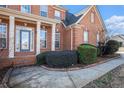 Front entry with brick columns, a blue door and neatly trimmed shrubs at 2612 Grove Park Ln, Conyers, GA 30094