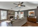 Sunlit living room with hardwood floors and stone fireplace at 1107 Whatley Mill Ln, Lawrenceville, GA 30045