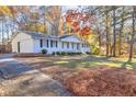 White brick ranch house with a driveway and mature landscaping at 2686 Abilene Trl, Snellville, GA 30078