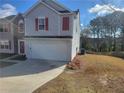 Two-story house with gray siding, red shutters, and a two-car garage at 1618 Water Lily Way, Lawrenceville, GA 30045