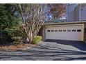 Front exterior of a two-story home with a paved driveway, attached garage, and stone accents at 43 Basswood Cir, Atlanta, GA 30328