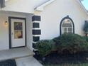 White front door with black trim and landscaping at 7092 Shore Rd, Lithonia, GA 30058