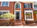 Front exterior of a two-story brick home with a black front door and large windows at 514 Lovinggood Ct, Woodstock, GA 30189