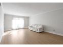 Bright living room with wood floors, white walls, and a white sofa at 6851 Roswell Rd # D14, Atlanta, GA 30328