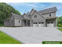 Gray farmhouse with three-car garage and large driveway at 776 Old Lathemtown Road, Canton, GA 30115