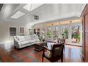Bright sunroom with large windows overlooking the backyard and pond at 7865 Nesbit Ferry Rd, Sandy Springs, GA 30350