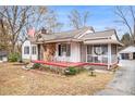 Home with white siding, a stone section, a red porch, and a screened-in area at 8451 Duncan St, Douglasville, GA 30134