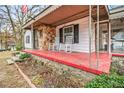 Close-up of a red porch with rocking chairs, stone accents, and white siding at 8451 Duncan St, Douglasville, GA 30134