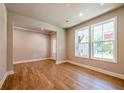 Spacious living room with hardwood floors and large windows at 7640 Homer Dr, Cumming, GA 30028