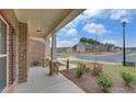 Covered front porch with stone columns overlooking a quiet neighborhood at 1721 Cobblefield Cir, Dacula, GA 30019