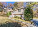 Two-story home with a red door and a landscaped front yard at 633 Larchmont Nw Cir, Atlanta, GA 30318