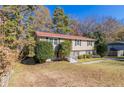 Charming two-story home nestled among trees with a welcoming front yard at 633 Larchmont Nw Cir, Atlanta, GA 30318