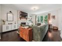 Spacious living room with a white brick fireplace and dark hardwood floors at 1900 Harper Nw Rd, Atlanta, GA 30318