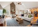 Open concept living room with a stone fireplace, vaulted ceilings, and abundant natural light at 265 Crooked Creek Trl, Canton, GA 30115