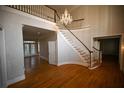Grand foyer with hardwood floors, curved staircase, and crystal chandelier at 1378 Wesley Oaks Nw Ct, Atlanta, GA 30327