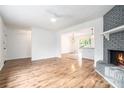 Spacious living room with fireplace, wood floors, and open concept layout connecting to the kitchen at 6709 Londonderry Dr, Morrow, GA 30260