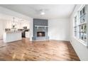 Open concept living room and kitchen with wood floors, fireplace, and lots of natural light at 6709 Londonderry Dr, Morrow, GA 30260