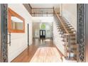 Two-story foyer with hardwood floors, elegant staircase, and mirror at 1472 Lachona Ct, Atlanta, GA 30329