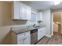 White cabinets, granite countertops, and stainless steel dishwasher at 2761 Whisper Ct, Douglasville, GA 30135