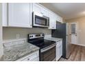 Kitchen features stainless steel range and microwave at 2761 Whisper Ct, Douglasville, GA 30135