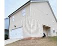 Back exterior view showcasing garage and siding at 1323 Rosemary Ln, Atlanta, GA 30344