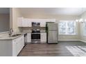 Bright and airy kitchen featuring white cabinetry, stainless steel appliances, and granite countertops at 2755 Sherlock Dr, Decatur, GA 30034