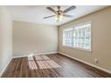Bright bedroom with hardwood floors and ceiling fan at 2126 River Rd, Ellenwood, GA 30294