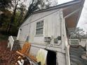 Side view of a single-story home showcasing the exterior wall and some debris at 97 Harper Rd, Atlanta, GA 30315