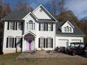 Two-story house with white siding, black shutters, and a pink door at 405 Baneberry Bnd, Peachtree City, GA 30269