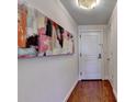 Entryway with hardwood floors and large artwork at 3338 Ne Peachtree Ne Rd # 1102, Atlanta, GA 30326