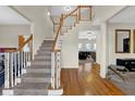 Grand staircase with wood railings and hardwood floors at 102 Twilight Overlook, Canton, GA 30114