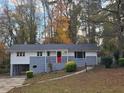 Ranch home with a red front door and wooded setting at 2652 Winthrop Rd, Atlanta, GA 30337