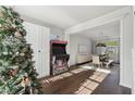 Open dining room with hardwood floors, a wooden table and a Christmas tree at 355 Arbor Creek Trl, Roswell, GA 30076