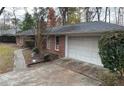 Brick home with attached garage and landscaped yard at 6698 Brandon Mill Rd, Atlanta, GA 30328