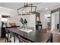 Dining room with modern chandelier, large table, and view into hallway at 6101 Marigold Way, Atlanta, GA 30349