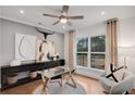 Modern home office with large window, stylish furniture, and hardwood floors at 6101 Marigold Way, Atlanta, GA 30349