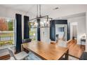 Bright dining room with large windows, hardwood floors, and a view of the home office at 6097 Marigold Way, Atlanta, GA 30349