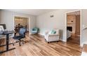 Bright living room with hardwood floors, comfy seating, and office area at 3090 Karen Ne Ln, Marietta, GA 30062