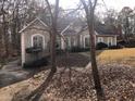 Exterior view of a two-story home with a driveway and trees at 209 Cobblestone Cv, Sharpsburg, GA 30277