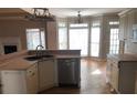 Spacious kitchen with an island, stainless steel appliances, and large windows at 209 Cobblestone Cv, Sharpsburg, GA 30277