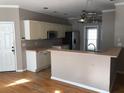Kitchen with white cabinetry, breakfast bar, and stainless steel appliances at 209 Cobblestone Cv, Sharpsburg, GA 30277